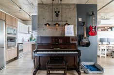 Acima: Aproveitar os elementos estruturais iAcima: Aproveitar os elementos estruturais da residência é a alma do estilo industrial. Neste projeto, o pilar de concreto ficou aparente e criou uma área de destaque para o piano | Foto: Guilherme Pucci